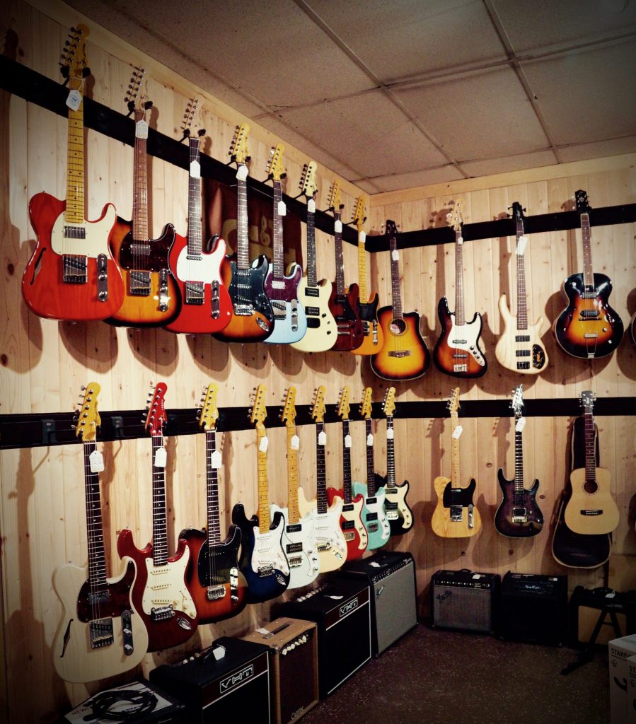 room full of electric guitars and guitar apps on the floor
